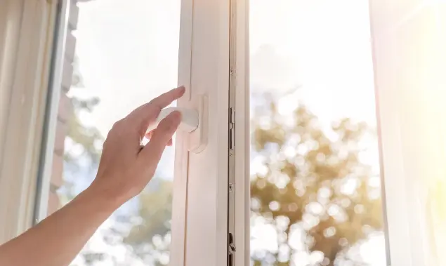 A window being opened to ventilate the room.